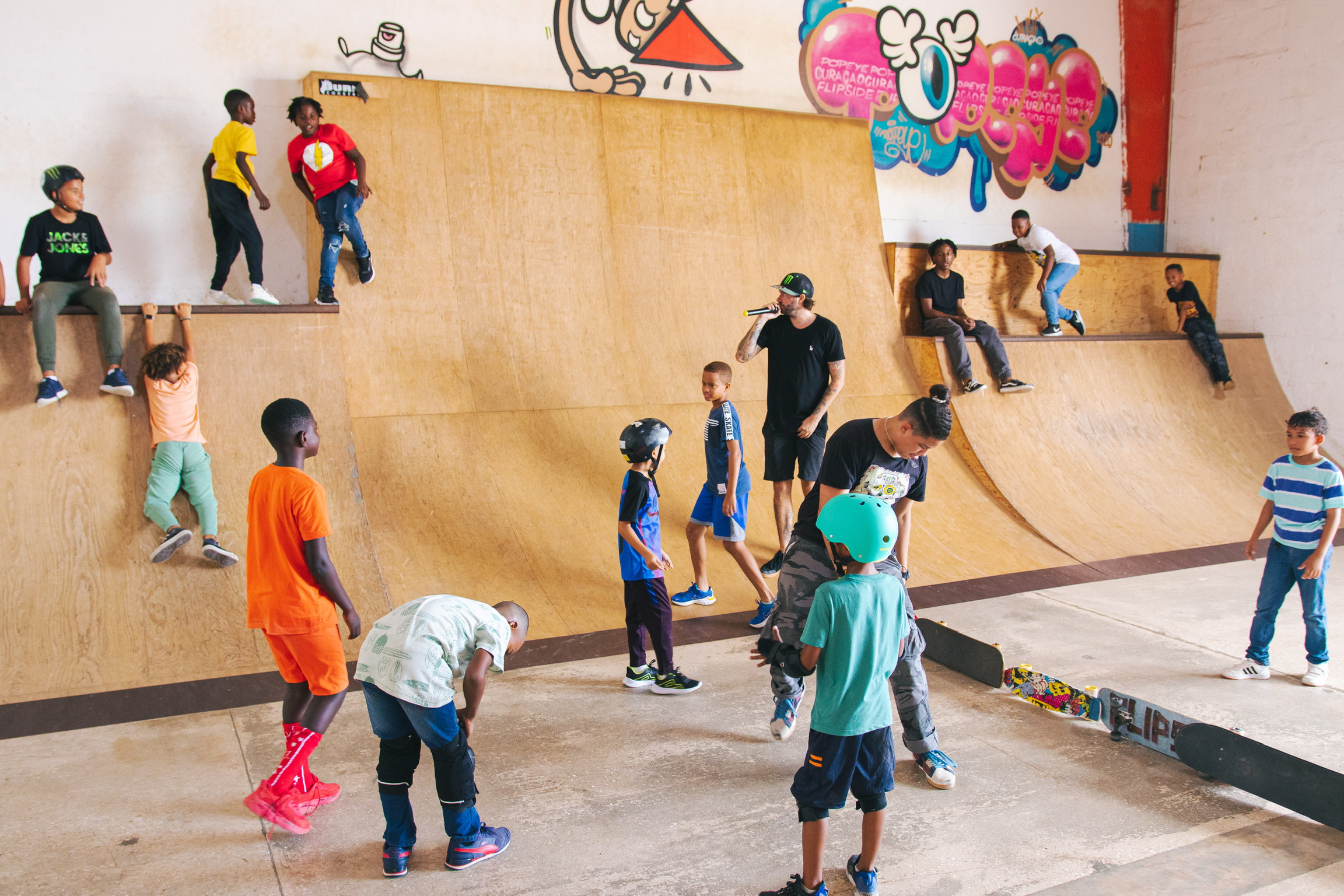 Young skateboarder at skate park indoor